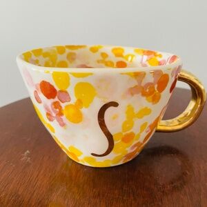 A contemporary ceramic mug by Sara Berenson with abstract floral design.